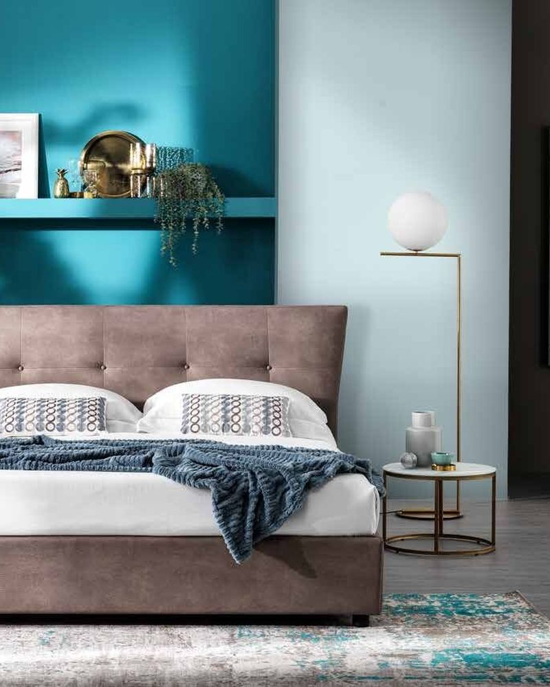 Orbit bed with a buttoned headboard and flared sides in taupe