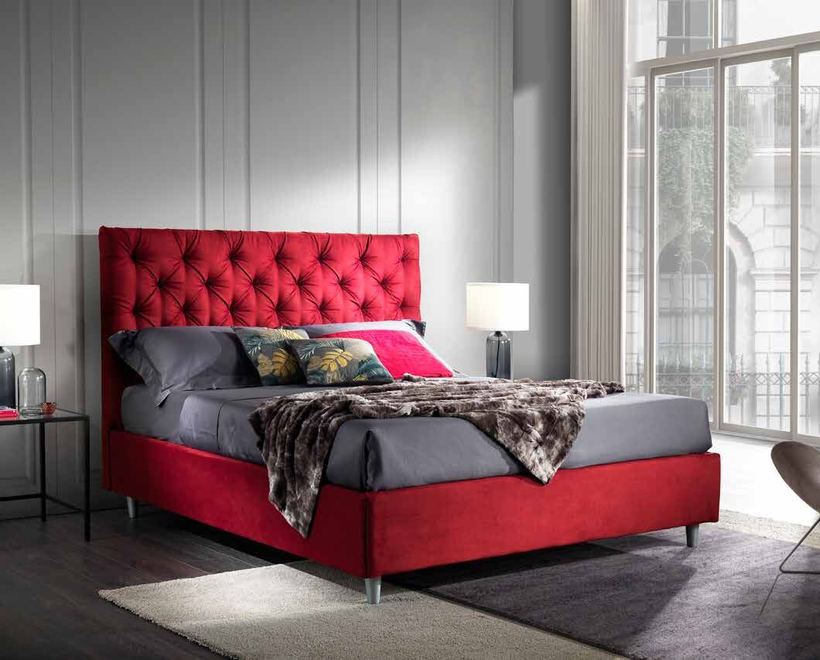 Virgo bed with a capitonné headboard in red velvet