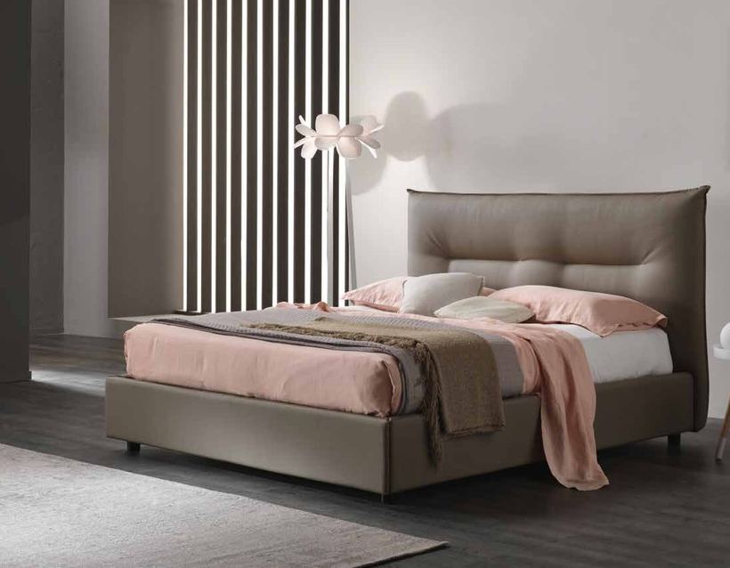 Vega upholstered bed with a soft padded headboard in a bedroom