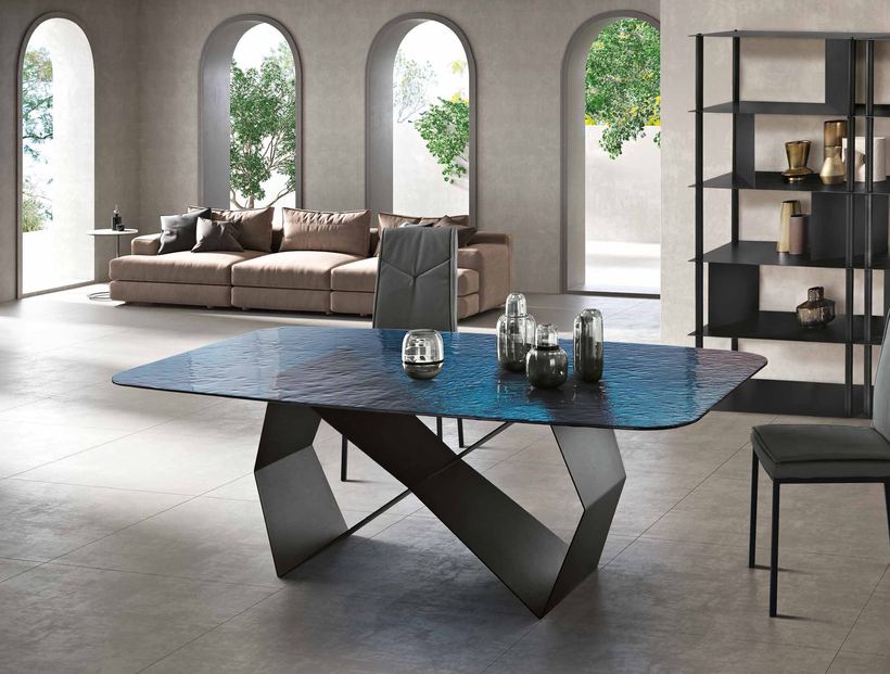Vino dining table with a blue hammered glass top on a black folded base