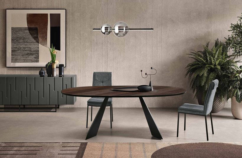Gusto oval dining table in dark oak on a black base