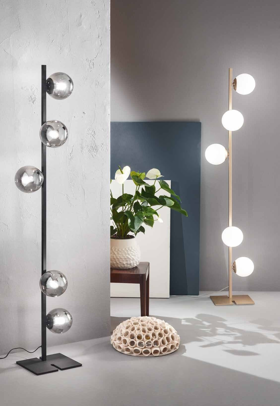 Lark floor lamps with glass globes, in black and in gold