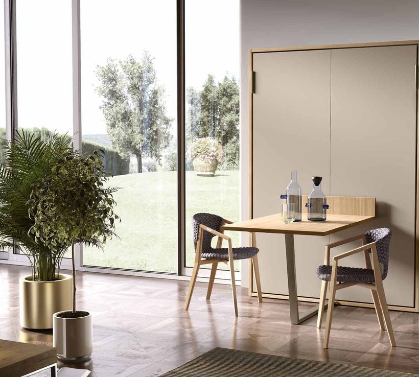 Mild wall bed closed, with its table folded out for dining