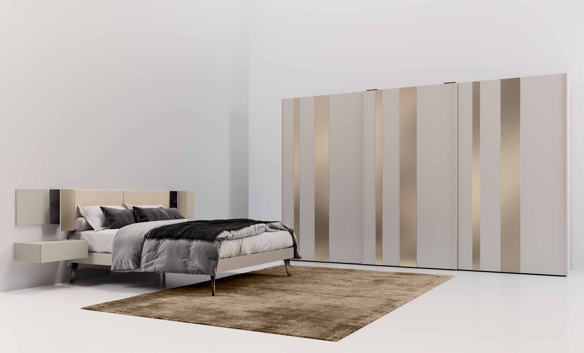 Hush long sliding wardrobe with bronze mirror strips in a bedroom