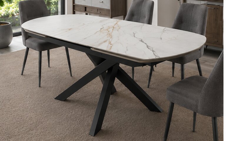 Oval ceramic-top extending table with its extension leaf in place on a sculptural black base
