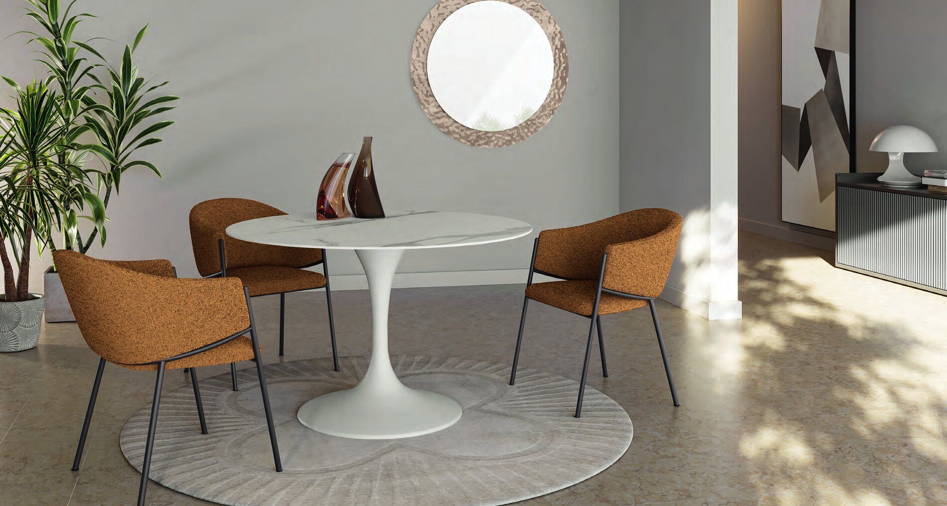 Four terracotta boucle dining armchairs around a round pedestal table