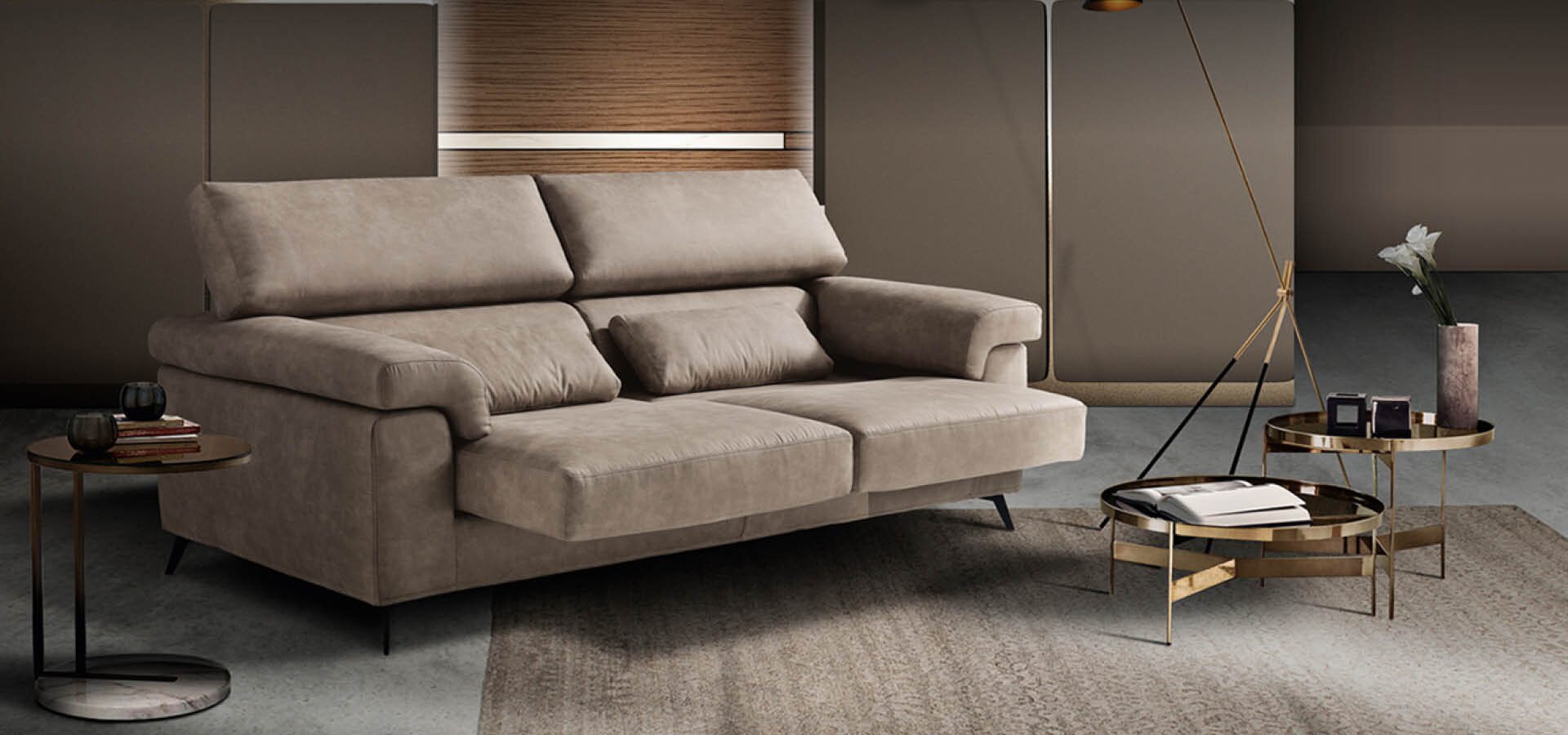 Taupe fabric sofa with adjustable headrests in a warm panelled room